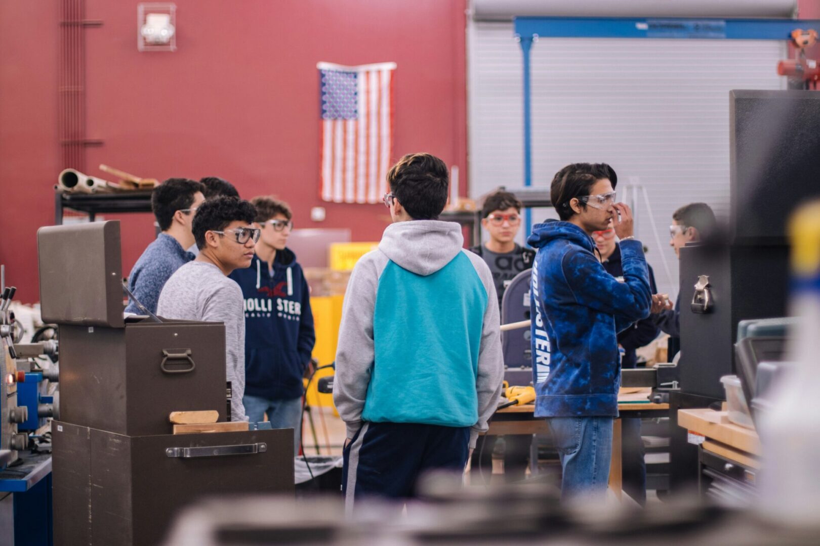 A group of people standing around in a room.