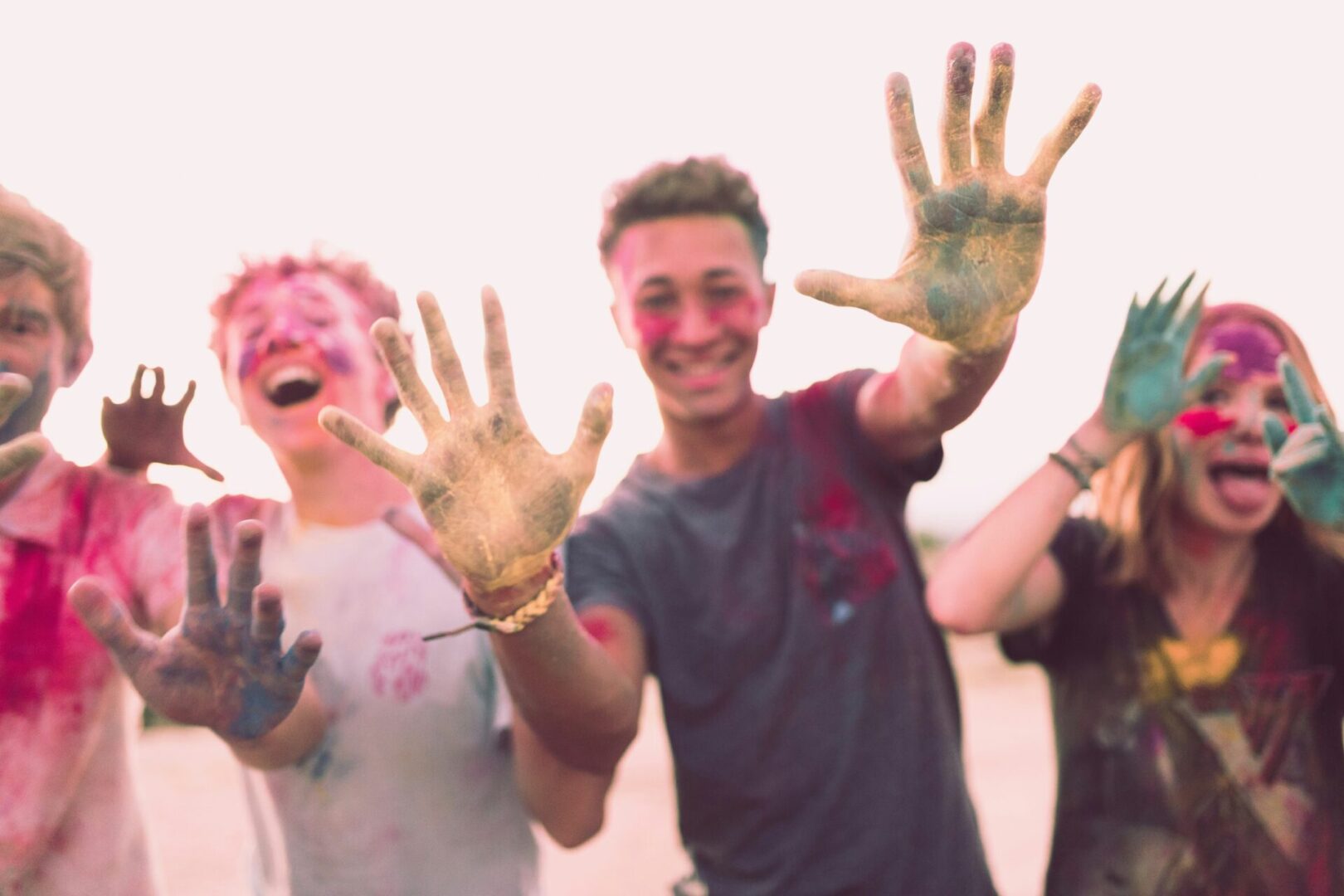 A group of people with paint on their hands.