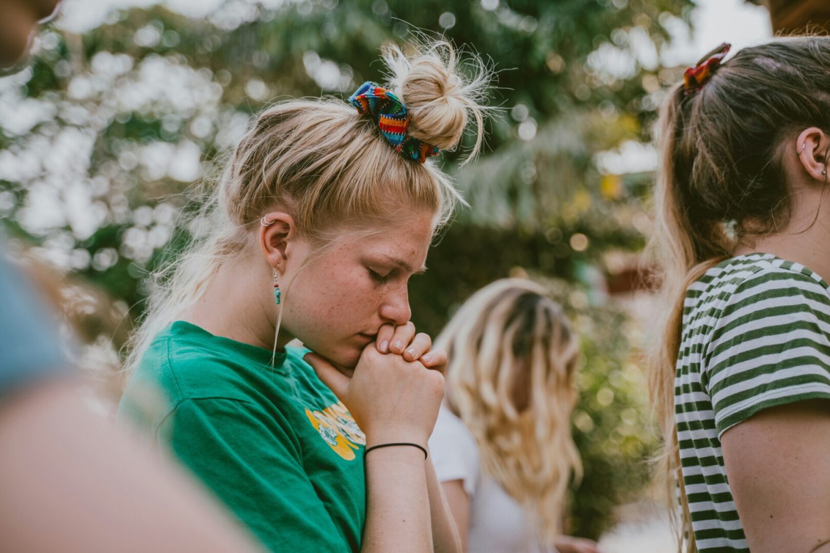 A girl with her head down praying.