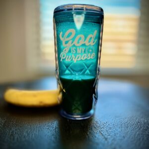 A blue cup with the words god is my purpose on it.